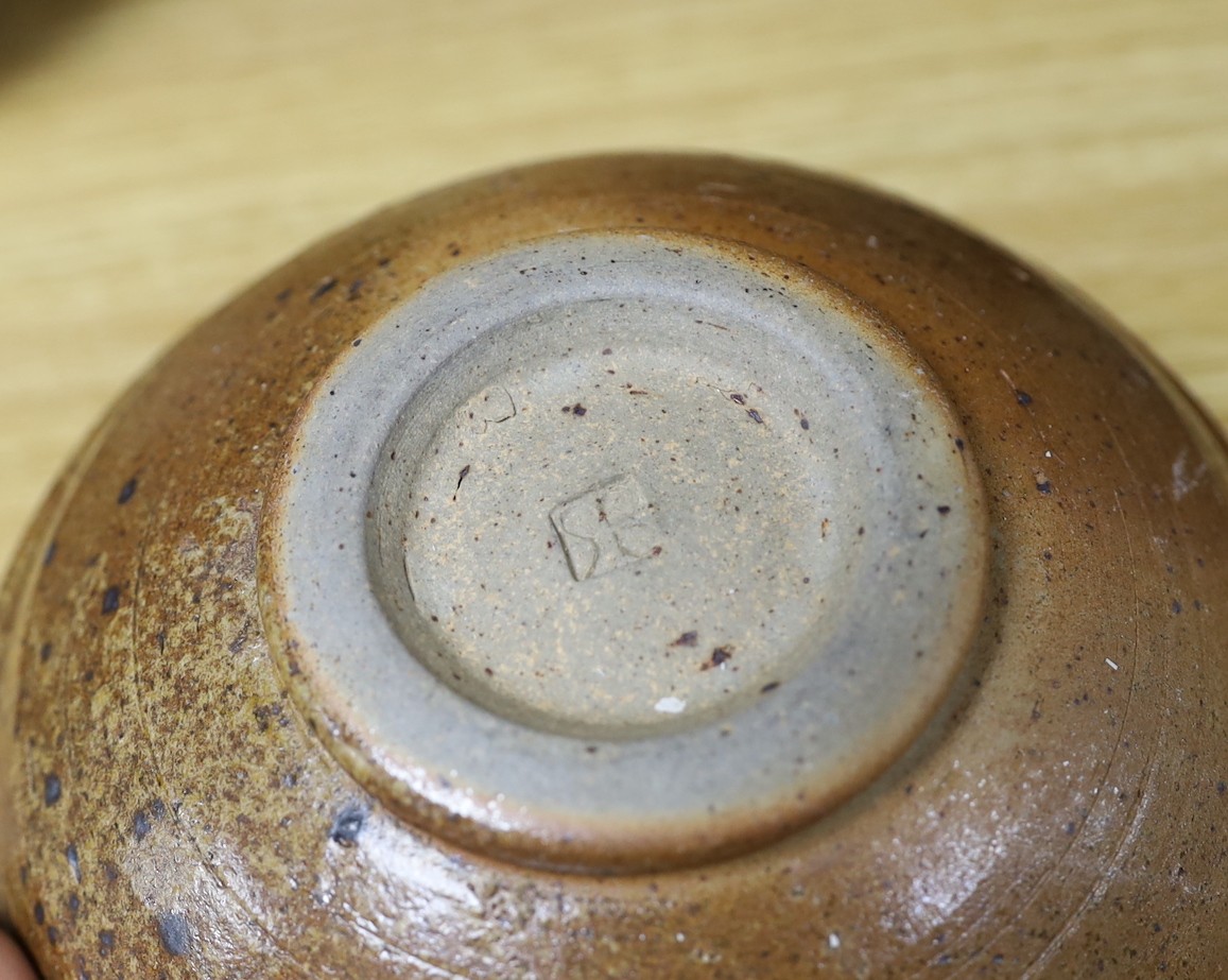 A large pottery figural tile together with a collection of studio pottery bowls